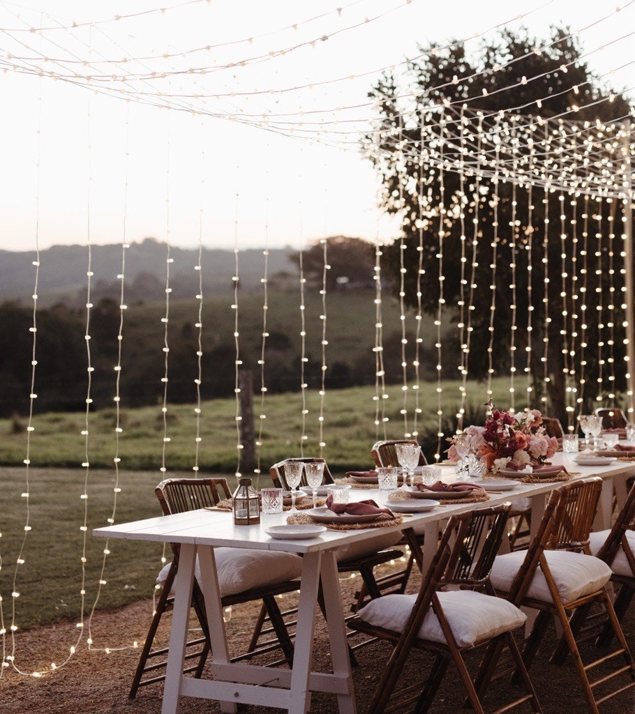 Table setting with fairy lights at dusk.